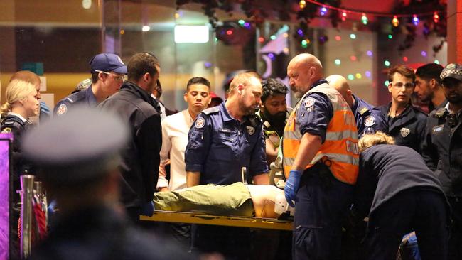 Police had to protect paramedics in Darling Harbour last month while they treated an unconscious woman.