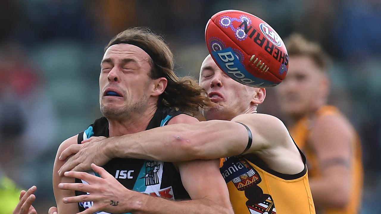 Jarrod Lienert of the Power (left) and Tom Scully of the Hawks contest during the Round 10 match in Launceston Picture: AAP Image/Julian Smith