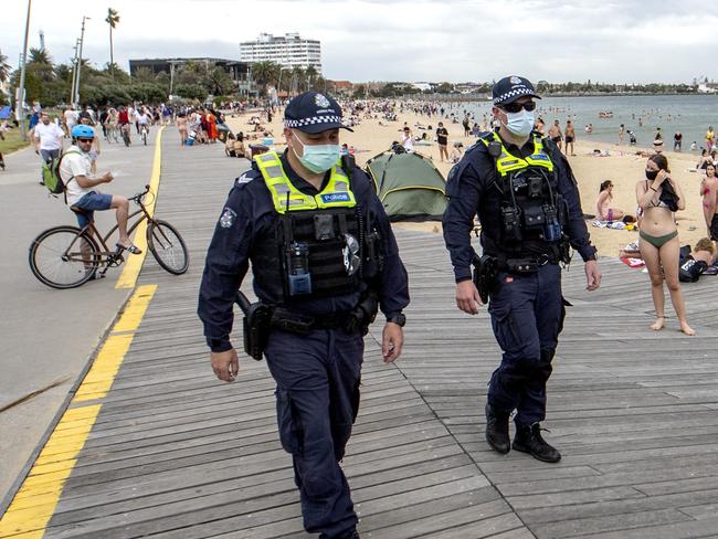 MELBOURNE, AUSTRALIA - NewsWire Photos November 15 2020: Police patrol a crowded St Kilda beach on Sunday afternoon as Covid restrictions ease and Melbourne temperatures reach over thirty degrees.  Picture: NCA NewsWire / David Geraghty