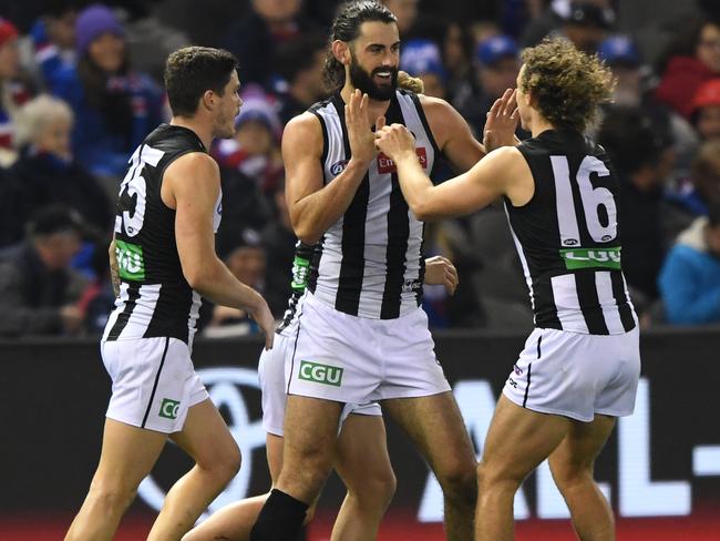 Brodie Grundy of the Magpies (centre) reacts after kicking a goal during his huge effort against Western Bulldogs on Sunday. Picture: AAP Image/Julian Smith