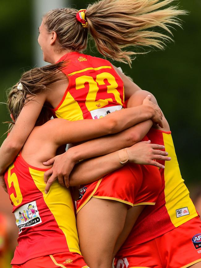 Howarth celebrates one of her four goals with her teammates. Picture: AFL Photos/Getty Images