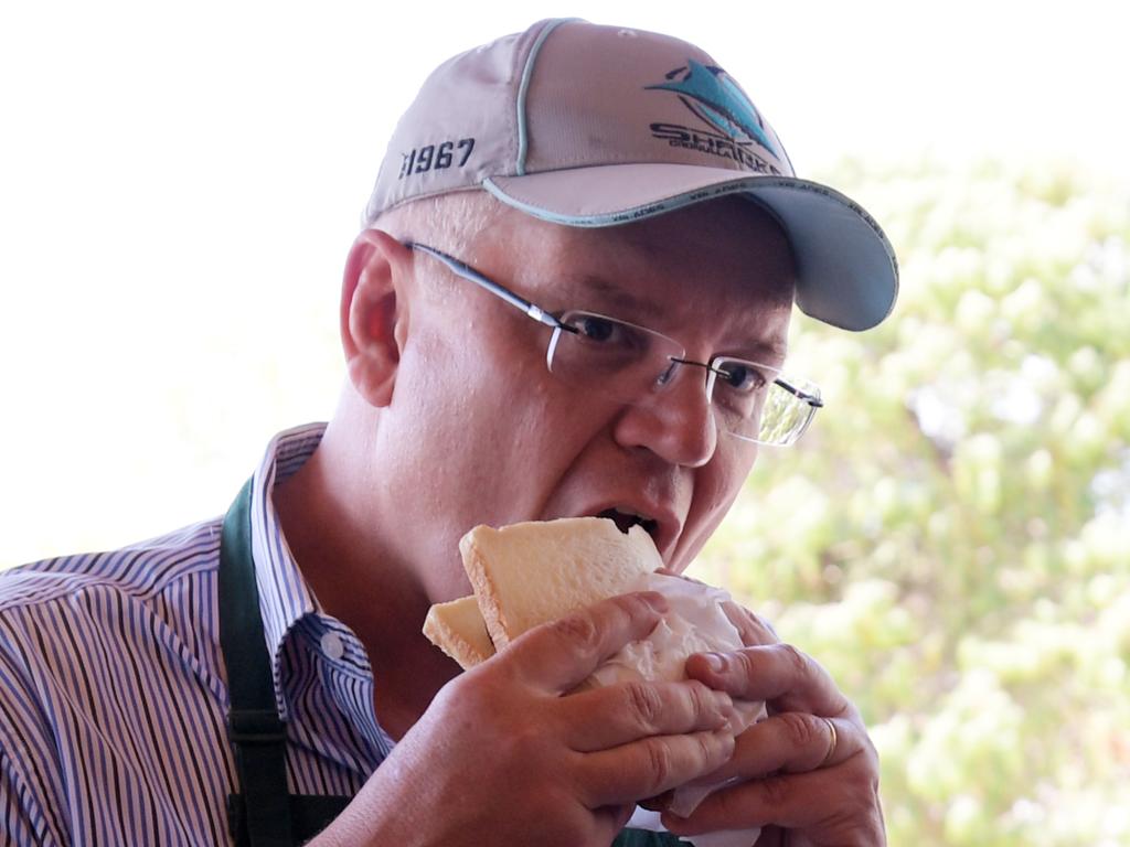 Voting day, complete with politicians eating snags in bread, is a great Australian tradition. Picture: Tracey Nearmy
