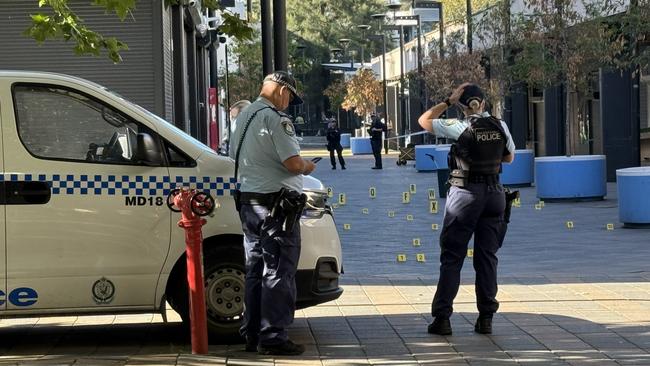 Police within the crime scene outside Universal Barber shop in Mount Druitt. Picture: Aymon Bertah