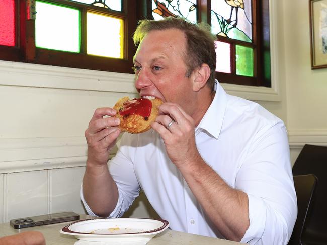 Premier Steven Miles stops at Yatala Pies and has a steak, bacon and cheese pie with candidate Chris Johnson on the last day of the Queensland Election campaigning ahead of Saturdays Election Day. Pics Adam Head