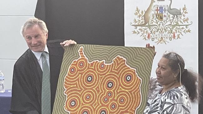 Justice Steven Rares was presented with a traditional artwork by Aunty Lois Johnson (painted by Gilbert Laurie). Justice Rares told the assembly the artwork would be displayed in a prominent spot at the Federal Court.