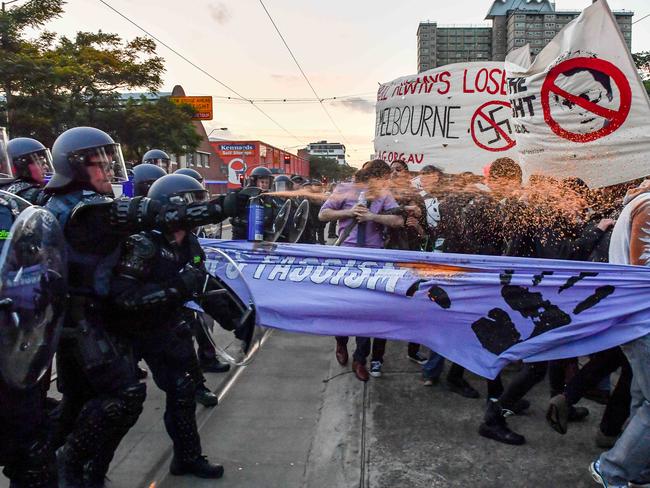 Police use pepper spray to disperse protesters. Picture: Jake Nowakowski
