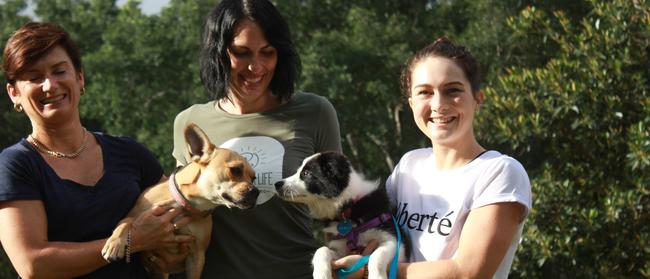 Victoria Aley and Molly (left), A Furever Life Canine Trainer Shannon Ratahi and Courteney Newton with 13 week old Hadley. 