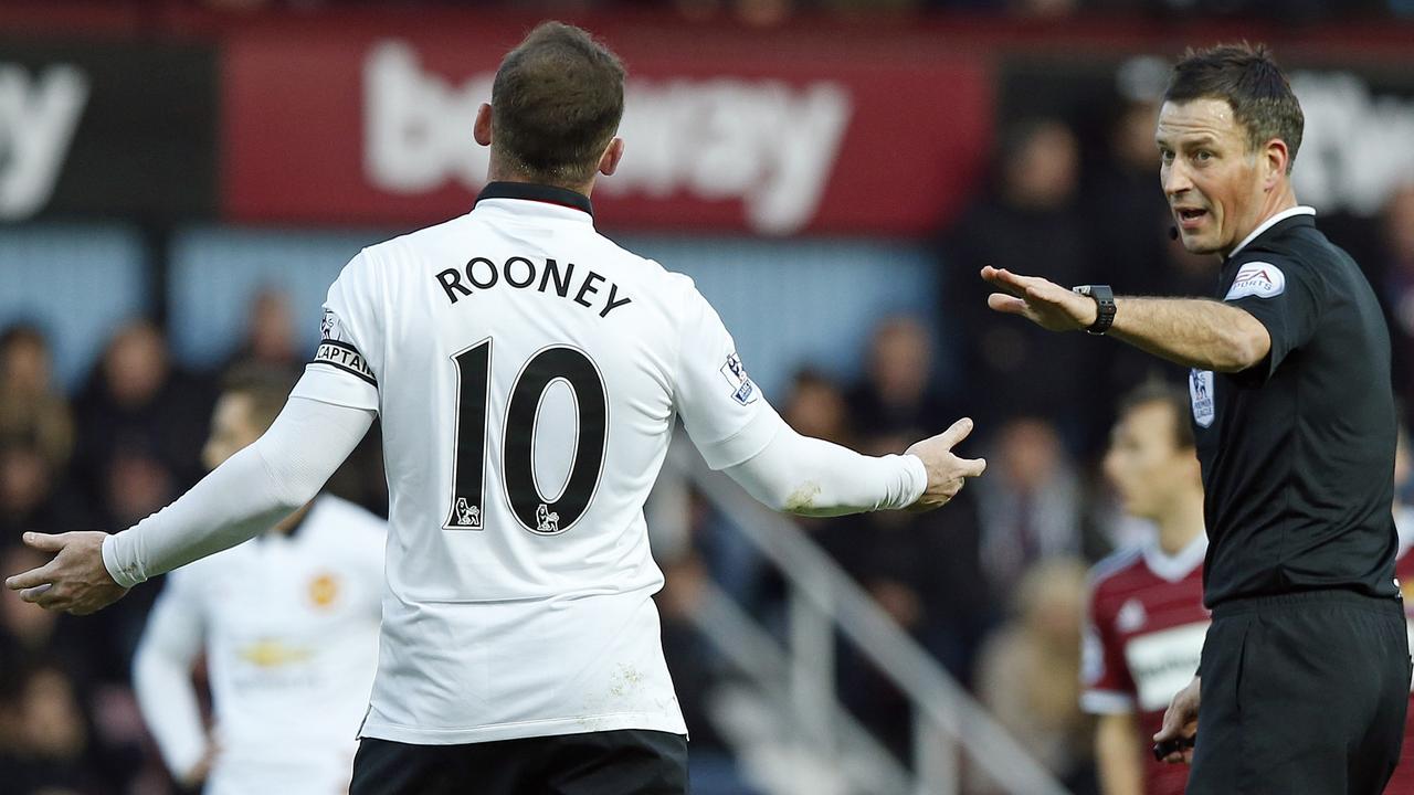 Referee Mark Calattenburg gestures as he speaks with Manchester United’s Wayne Rooney during the English Premier League soccer match between West Ham United and Manchester United at the Boleyn Ground in London, Sunday, Feb. 8, 2015. (AP Photo/Alastair Grant)