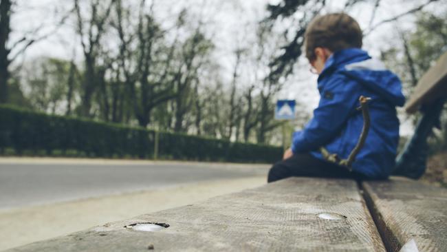 Sad boy. Lonely child. Vulnerable child. Thinkstock