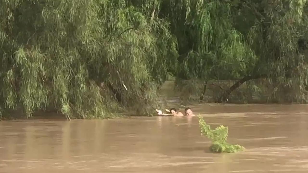 Three people, including a teenage girl and a hero cop have been rescued from floodwaters in Dalby. Picture: Anthony Gerard