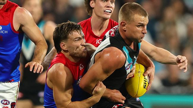 ADELAIDE, AUSTRALIA - MARCH 30: Ollie Wines of the Power is tackled by Jack Viney of the Demons during the 2024 AFL Round 03 match between the Port Adelaide Power and the Melbourne Demons at Adelaide Oval on March 30, 2024 in Adelaide, Australia. (Photo by Sarah Reed/AFL Photos via Getty Images)