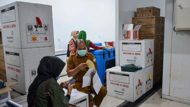 Indonesian health staff check Sinovac vaccines for the Covid-19 coronavirus at a storage facility before they are distributed to other provinces, in Banda Aceh.