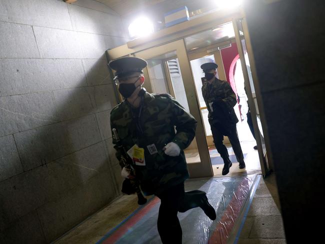 People are evacuated back inside after an "external security threat" prior to a dress rehearsal for the 59th inaugural ceremony for President-elect Joe Biden. Picture: Getty Images/AFP