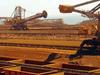(FILES) This file picture taken on March 4, 2010 shows remote-controlled stackers and reclaimers moving iron ore to rail cars at Rio Tinto's Port Dampier operations in Western Australia's Pilbara region. Australia's upper house on September 2, 2014, agreed to scrap a contested resources profits tax after the government struck a surprise deal with crossbench senators, including mining billionaire Clive Palmer. 
