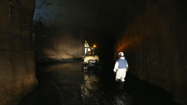 Gumboot territory ... the tunnel had been pumped dry, but the floot was still wet in places. Picture: Tim Hunter