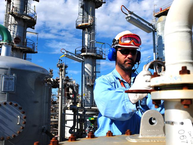 Uwe Klimmer, senior area operator, checks the diesel hydrotreater unit in the sour water plant at Caltex Australia Ltd.'s Lytton refinery in Brisbane, Australia, on Tuesday, Dec. 21, 2010. Caltex Australia is the nation's biggest oil refiner. Photographer: Eric Taylor/Bloomberg *** Local Caption *** Uwe Klimmer