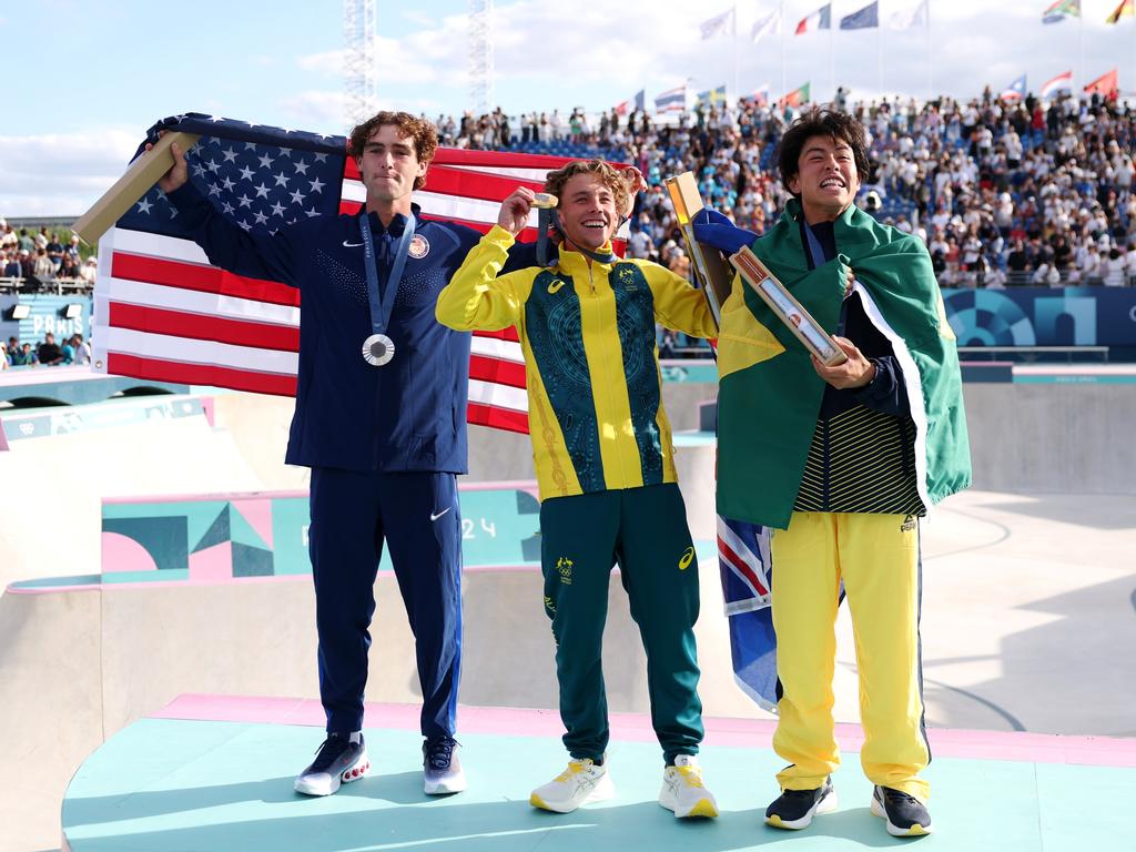 Gold medallist Keegan Palmer of Team Australia, centre, with silver medallist Tom Schaar of Team United States, left, and Bronze medallist Augusto Akio of Team Brazil, right, celebrate on the podium at Place de la Concorde on August 07 in Paris. Picture: Carl Recine/Getty Images