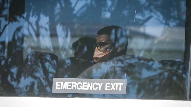 Passengers from the flight are transported from RAAF BASE Darwin to the Howard Springs quarantine facility on-board buses. Picture: Glenn Campbell