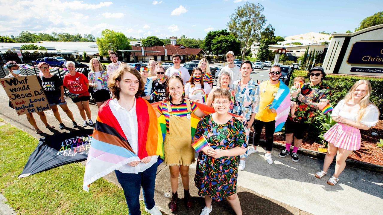 Emmey Leo, Felicity Myers and Bethany Lau gather with others to protest outside Citipointe Christian College on Monday. Picture: Richard Walker