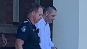 Kenneth James Hampton is led away from Gympie District Court on Friday, March 26, 2021.