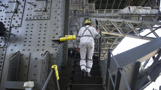 Justin Buhs, a senior painter on the Sydney Harbour Bridge, climbs the steps. Photos: Chris McKeen