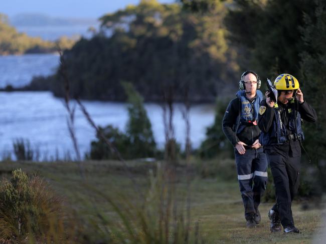 Tasmania Police helicopter crews returning to Pedder Wilderness Lodge late yesterday. Picture: LUKE BOWDEN