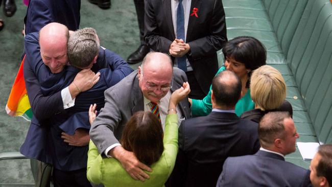 Members of Parliament embrace one another after parliament passed the same-sex marriage bill last week.