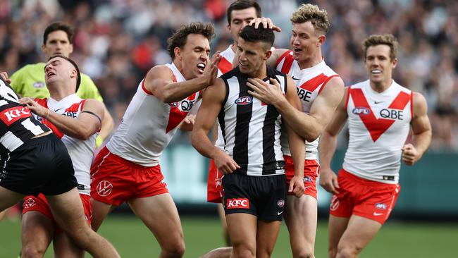 MELBOURNE. 06/05/2023. AFL. Round 8. Collingwood vs Sydney at the MCG. Swans players get stuck into Nick Daicos of the Magpies after a Ryan Clarke 1st qtr goal . Pic: Michael Klein