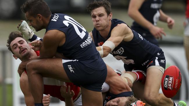 South Adelaide’s Rigby Barnes, Ben Heaslip and Adam Hunter tackle North Adelaide’s Alexander Spina.