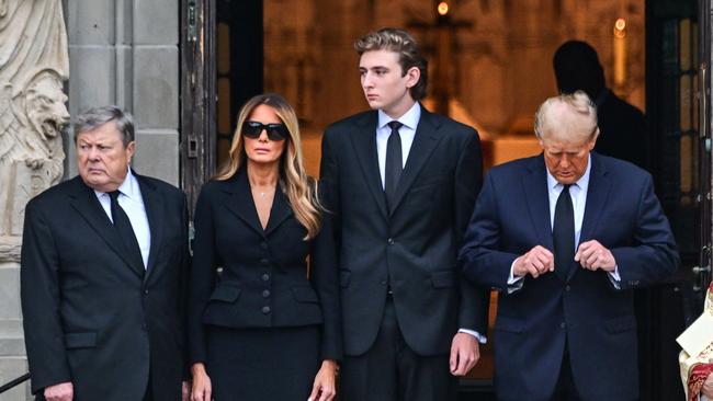 Former US President Donald Trump (R) stands with his wife Melania Trump (2L) their son Barron Trump (C) and father-in-law Viktor Knavs, at the funeral for Amalija Knavs, the former first lady's mother. Picture: Girogio Viera/AFP