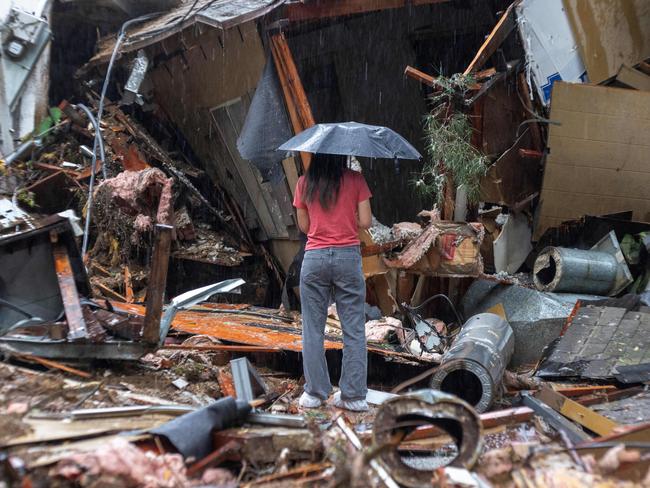 A woman surveys the remains of her Hollywood Hills home, which was destroyed by a landslide after a storm unleashed a month’s rain in a single day. Picture: David McNew/AFP