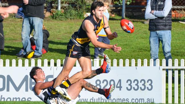 Glenelg’s Max Proud is tackled by Port Adelaide’s Aidyn Johnson during the Tigers’ big win. Picture: AAP/Brenton Edwards