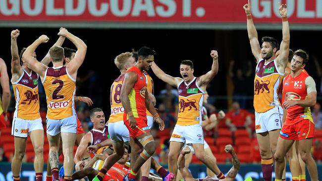 Brisbane players celebrate the Round 1 QClash win in 2017. Picture: Adam Head