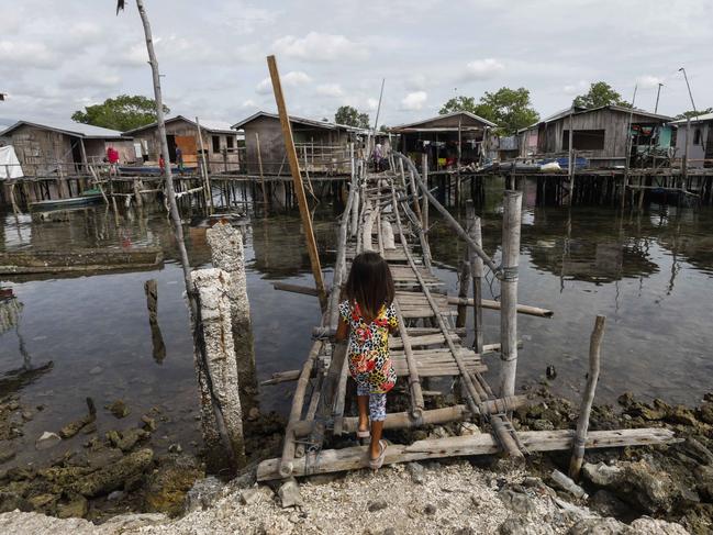 A child walks over to a bridge in Simariki coastal district in Zamboanga City, southern Philippines. Picture: EPA