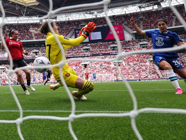 Chelsea's Australian striker Sam Kerr (R) shoots and scores past Manchester United's English goalkeeper Mary Earps during the English Women's FA Cup final football match between Chelsea and Manchester United at Wembley Stadium in London on May 14, 2023. (Photo by Adrian DENNIS / AFP)