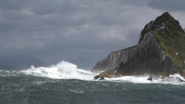 Huge Southern Ocean swells smash into the Breaksea Islands at Port Davey in Tasmania's Southwest National Park as part of the World Heritage Wilderness Area. Picture: PETER MARMION