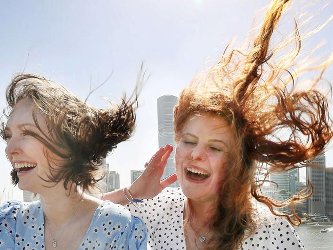 Britney Worbey, 19, and Sarah Purcell, 19, battling the wind at Kangaroo Point. Contact Sarah 0456993821. Pics Tara Croser.