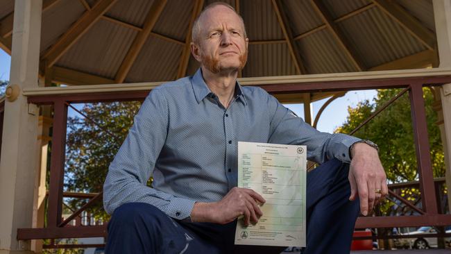 Dr Damian Adams with his newly issued birth certificate. Picture: Ben Clark
