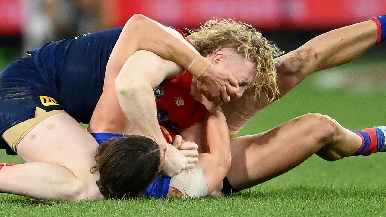 Jarrod Berry reaches for Clayton Oliver’s face as they wrestle during the third quarter. Picture: Quinn Rooney/Getty Images