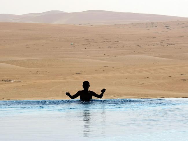 Your hotel pool laps the expansive Liwa Desert. AFP PHOTO / KARIM SAHIB