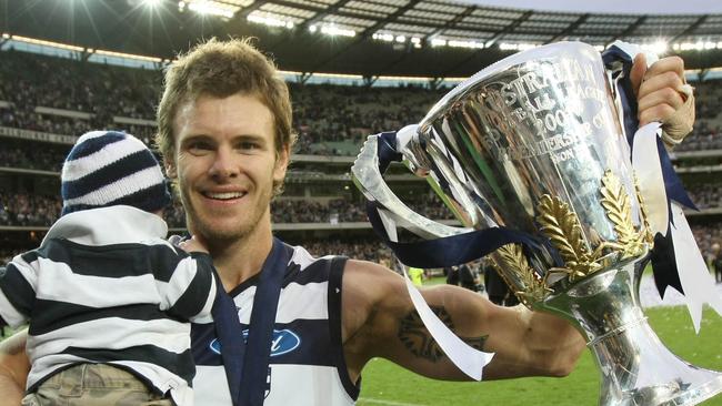 2007 Grand Final. Geelong v Port Adelaide. MCG. Cameron Mooney with the premiership cup and his son Jagger.