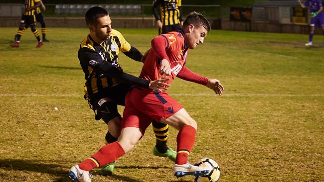 Birkalla’s Oliver Zafirdis and Adelaide's Ryan Strain during a friendly in 2018. Picture: Matt Loxton