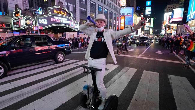 People celebrate in the streets before US president-elect Joe Biden delivers remarks from Delaware, in Times Square, New York. Picture: Timothy A Clary/AFP