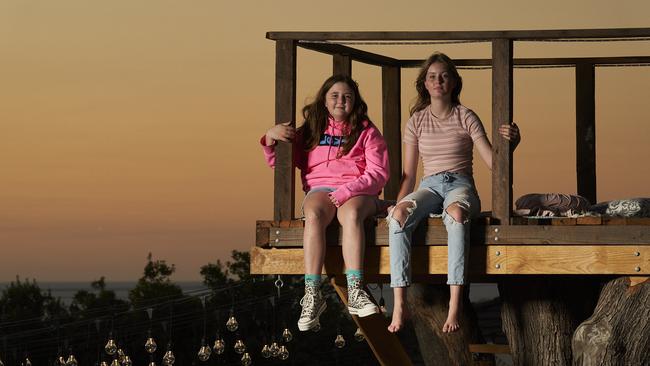 Delilah, 11, and Zenayah, 13, enjoy the view from the Seaview Downs treehouse. Picture: Matt Loxton