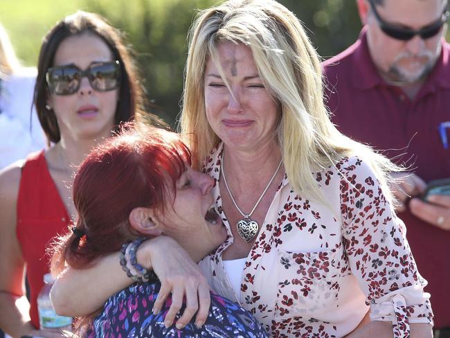 Parents wait for news following the horrific mass shooting. Picture: Joel Auerbach/AP