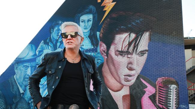 Baz Luhrmann in front of the Elvis Presley mural at Burleigh Heads. Picture: Scott Powick