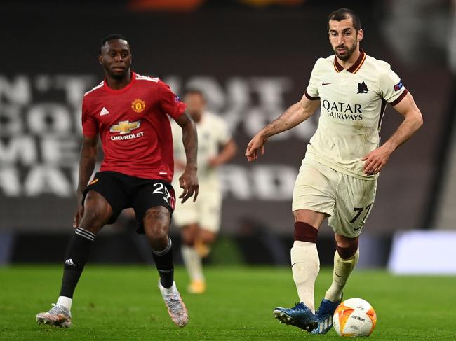 Henrikh Mkhitaryan of Roma battles for possession with Aaron Wan-Bissaka of Manchester United.