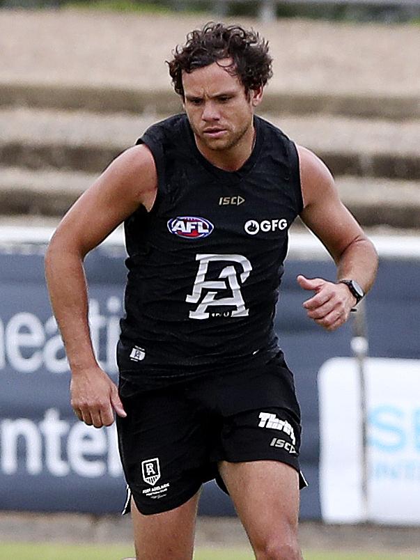 The midfield-forward pushes his selection case at training.