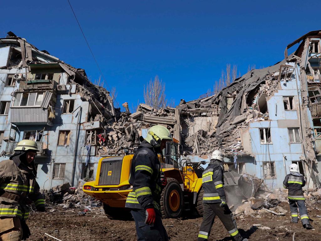 Ukrainian rescuers work on the five-storey residential building destroyed after a missile strike in Zaporizhzhia. Picture: AFP