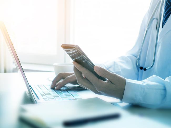 Doctor using smartphone in office